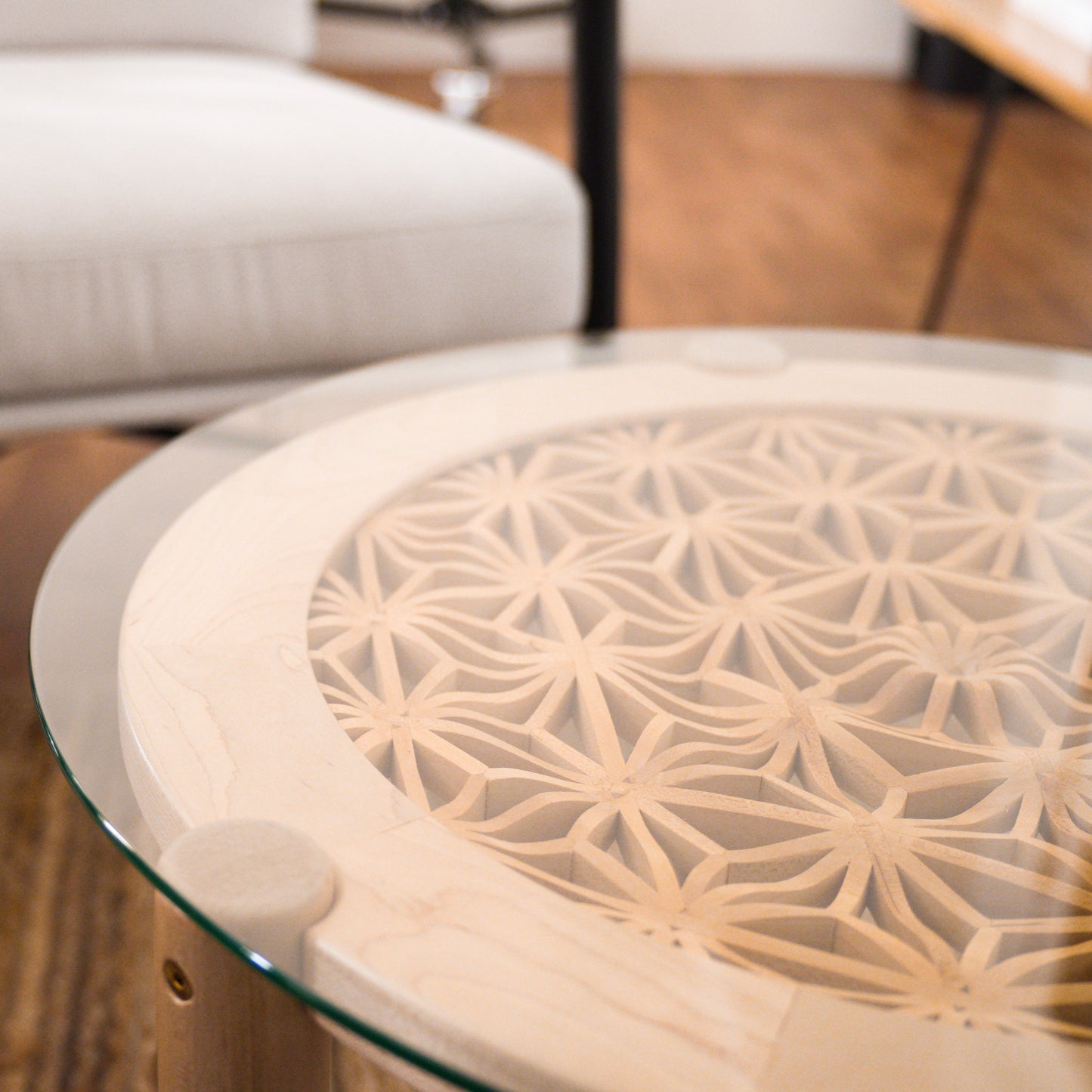 Table is made with maple and basswood with a glass top, displayed in a minimalist office.