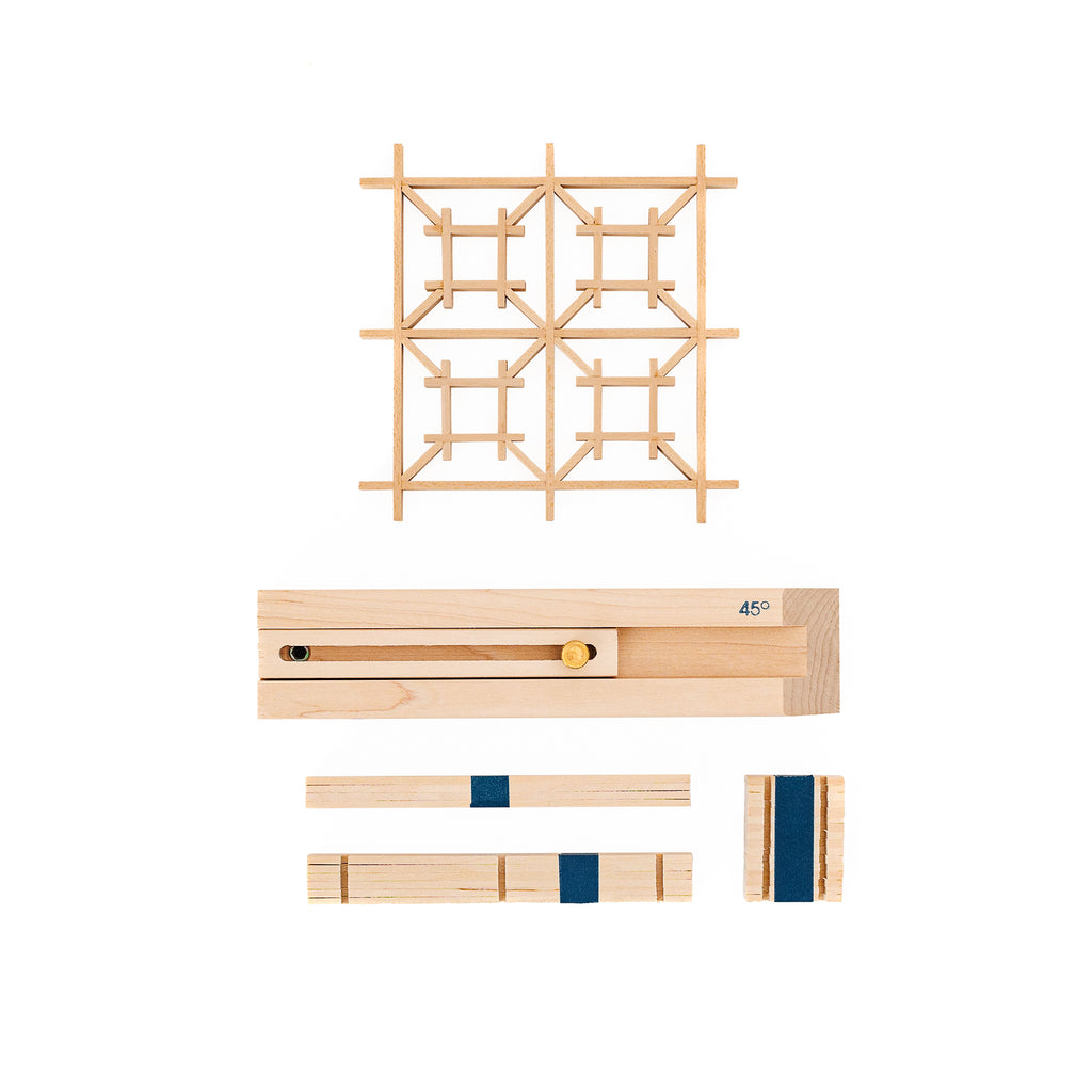 A flatlay display of Izutsu Kit supplies and tools, as well as a completed Izutsu kumiko panel.